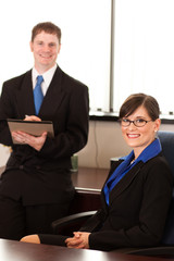 Happy Businesswoman and Businessman in Office - Business Concept