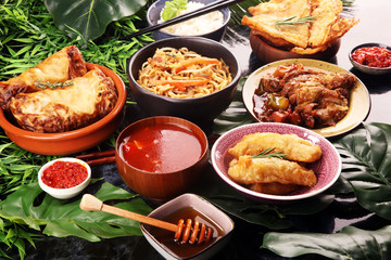 Assorted Chinese food set. Chinese noodles, fried rice, peking duck, dim sum, spring rolls. Famous Chinese cuisine dishes on table. Chinese restaurant