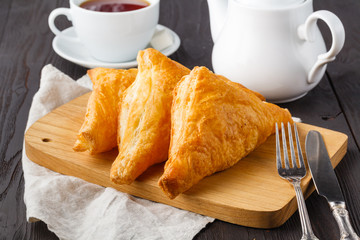 puff pastries triangles in wooden table