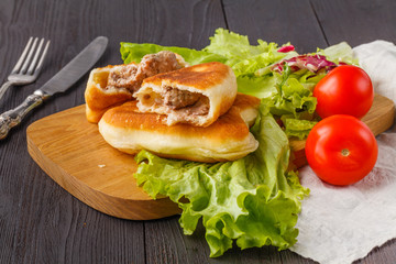 Triangular Russian belyashi with meat