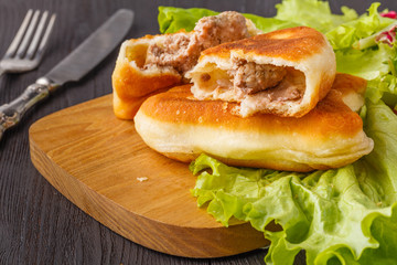 Triangular Russian belyashi with meat