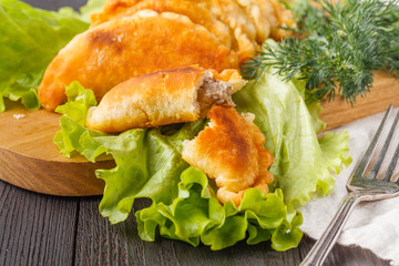 Savory stuffed patties on an wooden table. Country house style