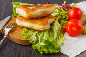 Savory stuffed patties on an wooden table. Country house style