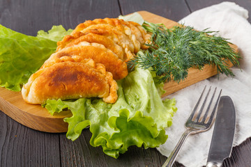 Savory stuffed patties on an wooden table. Country house style