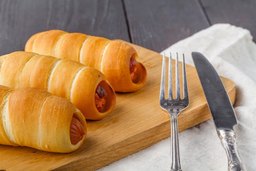 Home made pigs in a blanket. Sausages rolled in croissant dough, baked