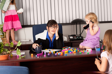 Stressed Businesswoman with Children in Office - Working Mom