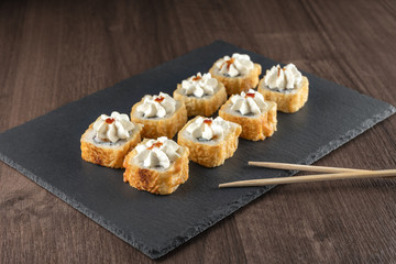 Baked rolls with a hat on a slate Board
