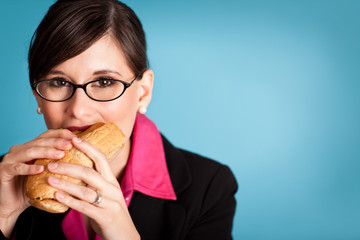 Happy Businesswoman Eating a Sub Sandwich - Business Portrait