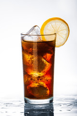 glass of cola with ice and lemon