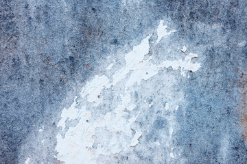 Pale blue stone texture of the wall. White paint stain on the surface. Copyspace.