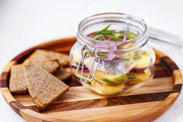 marinated herring with boiled potato and red onion