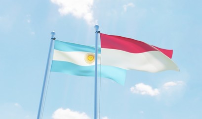 Argentina and Indonesia, two flags waving against blue sky. 3d image