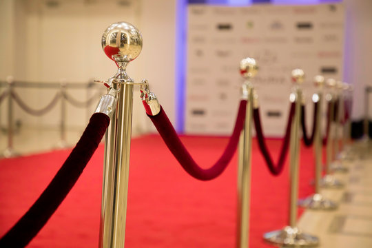 Red Carpet With Barriers And Velvet Ropes.