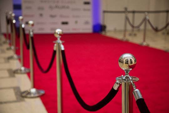Red carpet with barriers and velvet ropes.