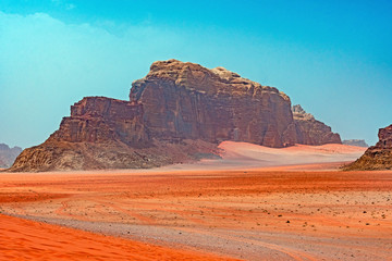 Distant Buttes in a Red Sand Desert
