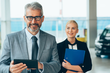 online customer support. car sales agents in car dealership showroom