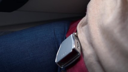 Woman fasten seat belt on the airplane. Safety first concept