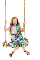 Little girl swinging on a swing