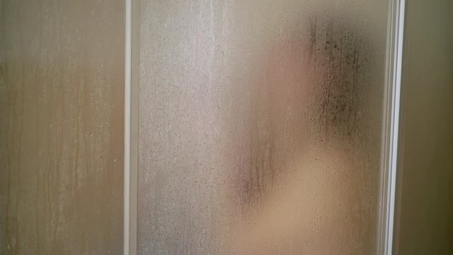 Young woman taking shower in bathroom