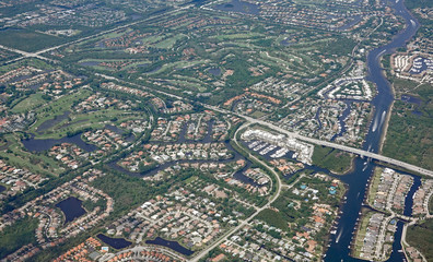 Aerial view of the Donald Ross Bridge in Juno Beach, Florida, and the surrounding gated golf...