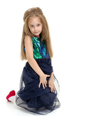 Fototapeta premium The little girl is on her knees.