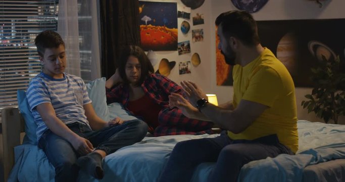 Father talking to son and daughter
