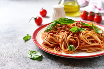 Traditional italian spaghetti bolognese with meat sauce, basil and parmesan cheese.