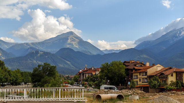 View of the street in Bansko town, Bulgarian ski resort in summer, Pirin Mountains in the background, Bulgaria.
