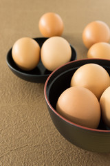 bowl of eggs on wood blownbackground