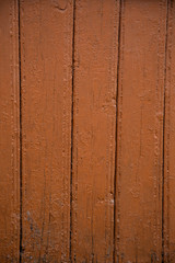 Old wooden background of boards with cracked and peeling paint. orange