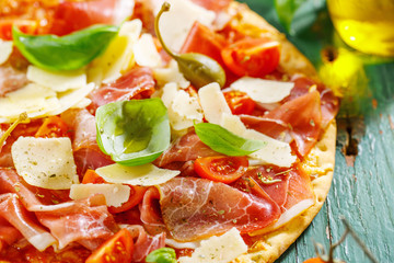Appetizing italian pizza with prosciutto