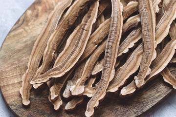 Slices of dried lingzhi mushroom, also called Reishi, on a wooden board
