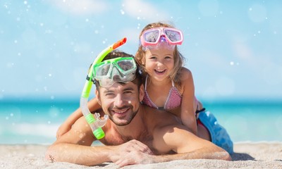 Happy father and his sweet little daughter at beach
