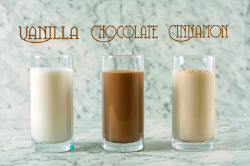 Nutritious vanilla, chocolate and cinnamon almond milk in glasses.