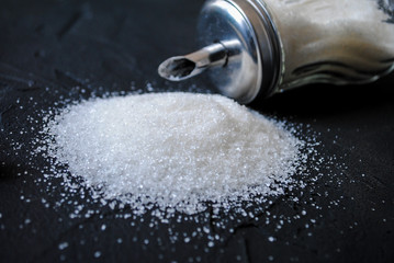 Sugar on the table and glass jar