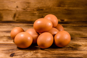 Pile of the hen eggs on wooden table