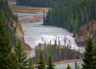 Waterfall surrounded by nature and wildlife. Rocky mountain ( Canadian Rockies ). Near the city of...