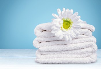 Laundry Basket with colorful towels on background