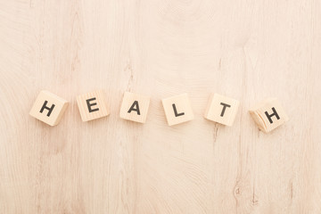 top view of cubes with health lettering on wooden background