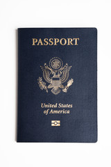 The iconic dark blue cover with gold stamp of an american passport set on a plain white background.