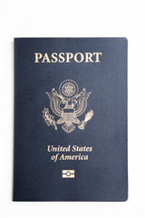 The iconic blue cover of an American passport deliberately and artistically set on a plain white background.