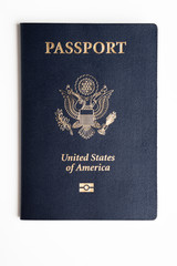 The iconic blue cover of an American passport deliberately and artistically set on a plain white background.