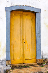 Old and aged historic church door from the Empire era in colonial wooden architecture in the city of Ouro Preto, Minas Gerais