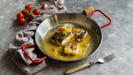 bacalao al pil pil, salted cod in emulsified olive oil sauce, spanish cuisine, basque country