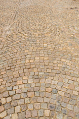 Wet cobblestone street in a swirl pattern for background or t