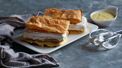 Costrada or millefeuille with - traditional dessert made with puff pastry, cream and custard. Milhojas de merengue y crema, Costrada de Alcala