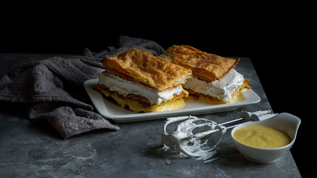 Costrada or millefeuille with - traditional dessert made with puff pastry, cream and custard. Milhojas de merengue y crema, Costrada de Alcala