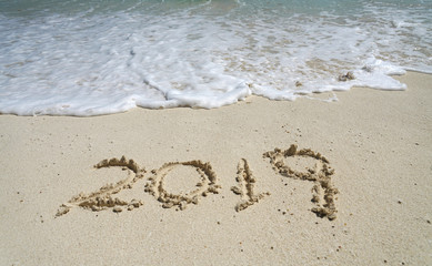 text of year 2019 on the beach sand