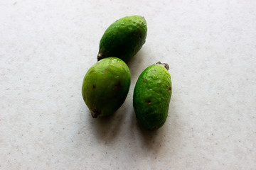 Green feijoa fruits on white background