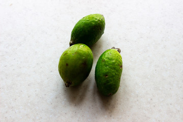 Green feijoa fruits on white background